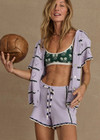 THE UPSIDE women's lilac organic cotton Amara Roller Knit Short is a relaxed fit featuring an elasticated waistband with drawcord and an open knit heart design down sides. Made for tennis, golf & pickleball.