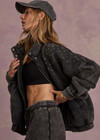 THE UPSIDE women's washed black Cosmic Carmen Moto Jacket is designed for a relaxed fit and features silver meta snap buttons, welt pockets and a soft elasticated hem. Perfect everyday outerwear piece.