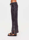 THE UPSIDE women's washed black Cosmic Wide Leg Shana Pant is a high waisted, wide-leg fit and features silver metal button snaps down leg that can be worn open.