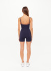 THE UPSIDE women's navy Form Seamless Jamie Bodysuit is firm and suportive and features a scooped neckline with a double layer bra with contrast tan underlayer. Made for pilates and yoga.
