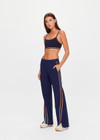 THE UPSIDE women's navy Toledo Petra Flare Pant features tan knitted tape down sides, an elasticated waistband, side pockets and splits at hem. Made for everyday wear.