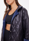 THE UPSIDE women's navy Levi Reversible Quilted Jacket is designed for a relaxed fit and features welt pockets, magnectic snap closure and a water resistant coating on black quilting. The perfect outerwear piece.