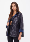 THE UPSIDE women's navy Levi Reversible Quilted Jacket is designed for a relaxed fit and features welt pockets, magnectic snap closure and a water resistant coating on black quilting. The perfect outerwear piece.