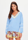 THE UPSIDE women's blue organic cotton Rever Josette V Neck Sweater is designed for a relaxed fit and features a striped V neckline in yellow and blue and contrast starts on sleeves. Made for everyday.