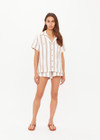 THE UPSIDE women's mocha stripe organic cotton Baja Katia Collared Shirt offers a relaxed fit and features a collar, patch pockets and wooden coconut buttons. Made for lifestyle.