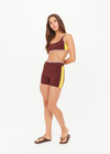 THE UPSIDE women's brown Montage Speechless Short offers a mid-rise fit with a soft waistband and features yellow side pannels, embroidered and rib detail. Made for yoga & pilates.