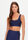 THE UPSIDE women's navy eco tech Toscan Harley Scoop Sports Bra is designed for mid coverage with a scoop front and back neckline, featuring removable cups and crafted with contrast mocha and cream binds. Made for yoga & pilates.