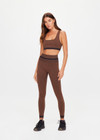 THE UPSIDE women's brown seamless Marle Seamless 25Inch Midi Legging offers a mid-rise with a black stripe at waistband. Made for yoga & pilates.