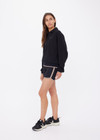 THE UPSIDE women's black organic cotton Collared Elle Polo is a relaxed fit long sleeve with a mocha stripe along ribbed hem and cuffs. Made for everyday wear.