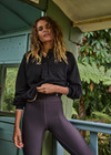 THE UPSIDE women's black organic cotton Collared Elle Polo is a relaxed fit long sleeve with a mocha stripe along ribbed hem and cuffs. Made for everyday wear.