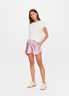 THE UPSIDE women's pink McGrath Billie Run Short is a mid-rise lightweight short in a metallic pink fabrication and features and side pockets and an elasticated waistband with drawcord. Made for lifestyle.