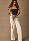 THE UPSIDE women's cream cotton Noosa Calling Track Pant is a low-rise straight leg pant with a soft elastic waistband, made from soft brushed recycled fabric. Made for lifestyle.