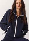 THE UPSIDE women’s navy recyled Sol Fleece Jacket offers a relaxed fit and features a zip through front, front zip pockets, elasticated waist and cuffs and contrast paracord zip pullers. Made for lifestyle.
