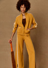 THE UPSIDE women's yellow organic cotton Bonito Dylan Knit Jacket offers a relaxed fit and features raglan sleeves, front patch pockets and contrast stripe detailing. Made for lifestyle.