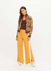THE UPSIDE women's yellow organic cotton Bonito Moby Knit Pant is designed for a soft and supportive fit and features a high rise waist, side stripe detailing and adjustable drawcord. Made for lifestyle.