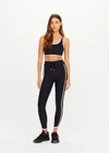 THE UPSIDE women's black Sol Jade Racerback Sports Bra is designed for a soft and supportive fit and features a scooped racerback, contrast binding and removable cups. Made for yoga and pilates.