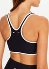THE UPSIDE women's black Sol Jade Racerback Sports Bra is designed for a soft and supportive fit and features a scooped racerback, contrast binding and removable cups. Made for yoga and pilates.