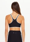 THE UPSIDE women's black Sol Jade Racerback Sports Bra is designed for a soft and supportive fit and features a scooped racerback, contrast binding and removable cups. Made for yoga and pilates.