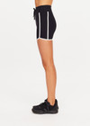 THE UPSIDE women's black Sol 3.5inch Spin Short offers a soft and supportive fit with a mid rise waist, side stripe detailing, pockets and adjustable drawcord. Made for yoga and pilates.