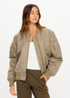 THE UPSIDE women's olive Tribute Bomber Jacket is a true to size style featuring a water resistant finish, paisley lining, ruched sleeve detailing and multiple utility pockets. Made for lifestyle.