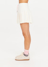 THE UPSIDE women’s cream recycled Cadiz Pleated Skirt is designed for a true to size fit and features a pleated design, built in inner short with pockets and drawcord detail. Made for tennis.