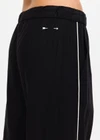 THE UPSIDE women's black lyocell linen blend Noir Elita Pant offers a true to size fit with a mid rise waist, contrast piping and slanted side seam pockets. Made for lifestyle.