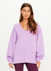 THE UPSIDE women's purple organic cotton Soul Lou V Neck Sweater offers an oversized fit with drop shoulders, ribbed trims and an embroidered logo detail. Made for lifestyle.