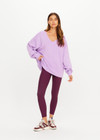 THE UPSIDE women's purple organic cotton Soul Lou V Neck Sweater offers an oversized fit with drop shoulders, ribbed trims and an embroidered logo detail. Made for lifestyle.