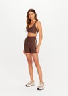 THE UPSIDE women's brown Daytona 5inch Spin Short offers a soft and supportive fit with a mid rise waist, contrast side binding and adjustable drawcord. Made for yoga and pilates.