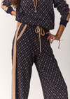 THE UPSIDE women's monogram jacquard Ezra Nova Flare Pant features a monogram geometric design and an elasticated waistband with drawcord. Made for lifestyle.