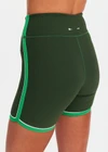 THE UPSIDE women's green Rhythm 5inch Spin Short is mid-rise and features cream and light green binds along side seams in our recycled rib fabrication. Made for yoga and pilates.