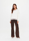 THE UPSIDE women's cream Millie V Neck Knit Sweater is designed for a relaxed fit and features a high v neckline and chocolate metallic stripes along cuffs, neckline and hem. Made for lifestyle.