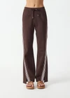 THE UPSIDE women's brown Petra Flare Pant is true to size with pink striped side tape and tonal drawcord with dipped ends. Made for lifestyle.