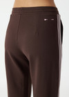THE UPSIDE women's brown Petra Flare Pant is true to size with pink striped side tape and tonal drawcord with dipped ends. Made for lifestyle.