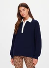 THE UPSIDE women's navy organic cotton Wonder Knit Polo is designed for a relaxed fit and features long sleeves with a contrast cream collar and placket. Made for lifestyle.