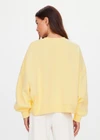 THE UPSIDE women's yellow organic cotton Paloma Crew is designed for a boxy fit and features a drop shoulder and ribbed neckline, hem and cuffs. Made for lifestyle.