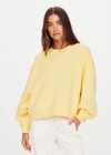 THE UPSIDE women's yellow organic cotton Paloma Crew is designed for a boxy fit and features a drop shoulder and ribbed neckline, hem and cuffs. Made for lifestyle.
