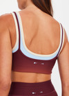 THE UPSIDE women's red recycled peached Maya Sal Double Layer Bra is mid coverage and features a scooped neckline, elasticated underbust and removable cups. Made for yoga and pilates.