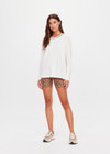 THE UPSIDE women's natural organic cotton Mali Long Sleeve Top is a relaxed fit and features a ribbed neckline in butter with navy piping. Made for lifestyle.