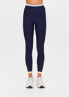 THE UPSIDE women's navy recycled nylon Hermosa 25 Inch Pocket Legging is mid rise and features a contrast hem cuff in butter and pockets at the side. Made for yoga and pilates.