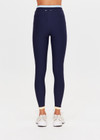THE UPSIDE women's navy recycled nylon Hermosa 25 Inch Pocket Legging is mid rise and features a contrast hem cuff in butter and pockets at the side. Made for yoga and pilates.
