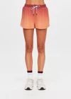 THE UPSIDE women's red recycled polyester Maya Billie Run Short is mid rise and features light blue mesh tape down side seams and side pockets. Made for running.