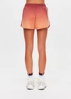 THE UPSIDE women's red recycled polyester Maya Billie Run Short is mid rise and features light blue mesh tape down side seams and side pockets. Made for running.