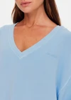 THE UPSIDE women's blue organic cotton Lou V Neck Sweater is an oversized fit and features dropped shoulders and a ribbed neckline and cuffs. Made for lifestyle.