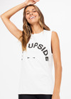 THE UPSIDE women's white Muscle Tank is made of organic cotton jersey. It features low-cut arm openings, rolled bind detail at the sleeve and a white horsehoe logo at the centre front.