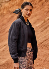 THE UPSIDE Kita Bomber Jacket in Black is sustainable classic bomber jacket with pockets, zip front closure, recycled insulation, and PCR free water repellent coating.