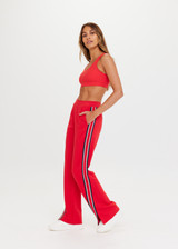 THE UPSIDE Petra Flare in Chilli is a sustainable flared pant with splits at front, contrast knitted tape down side seams, pockets and elastic at waist.
