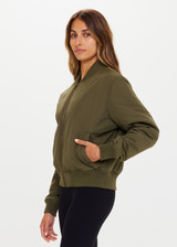 THE UPSIDE Kita Bomber Jacket in Khaki is sustainable classic bomber jacket with pockets, zip front closure, recycled insulation, and PCR free water repellent coating.