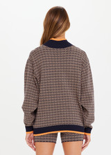 THE UPSIDE Castilla Clementine Knit Crew in our ‘T’ monogram Navy and Tan design is a sustainable relaxed fit, high neck chunky knit crew with rib knit neck, cuffs and hem and pops of orange.