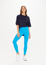 THE UPSIDE Peached 25inch High Midi Pant in Pool Blue is a recycled 25” midi length legging with a V shaped high-rise waistband and printed arrow logo at back.